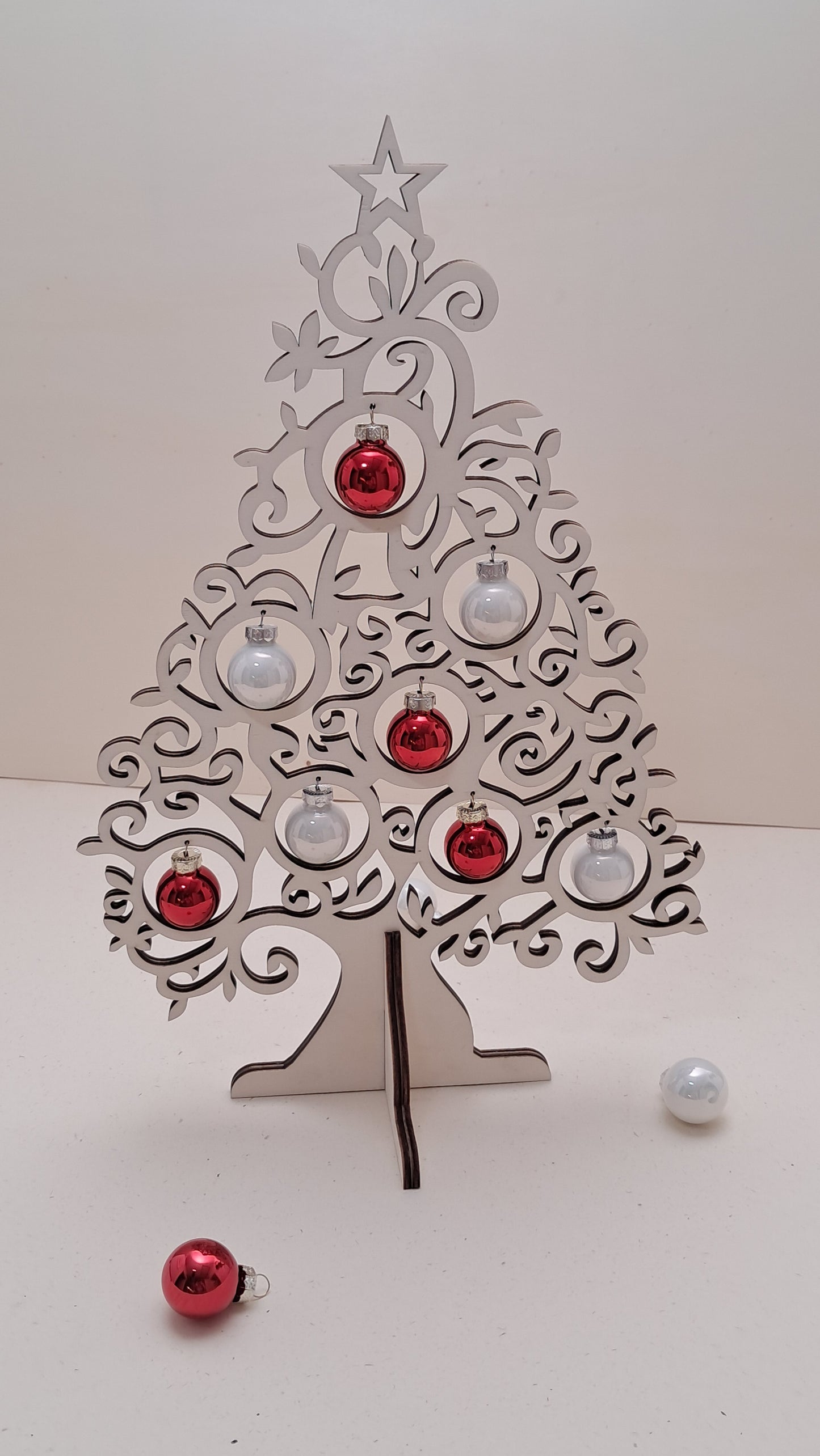 Wooden tabletop Christmas tree with glass baubles